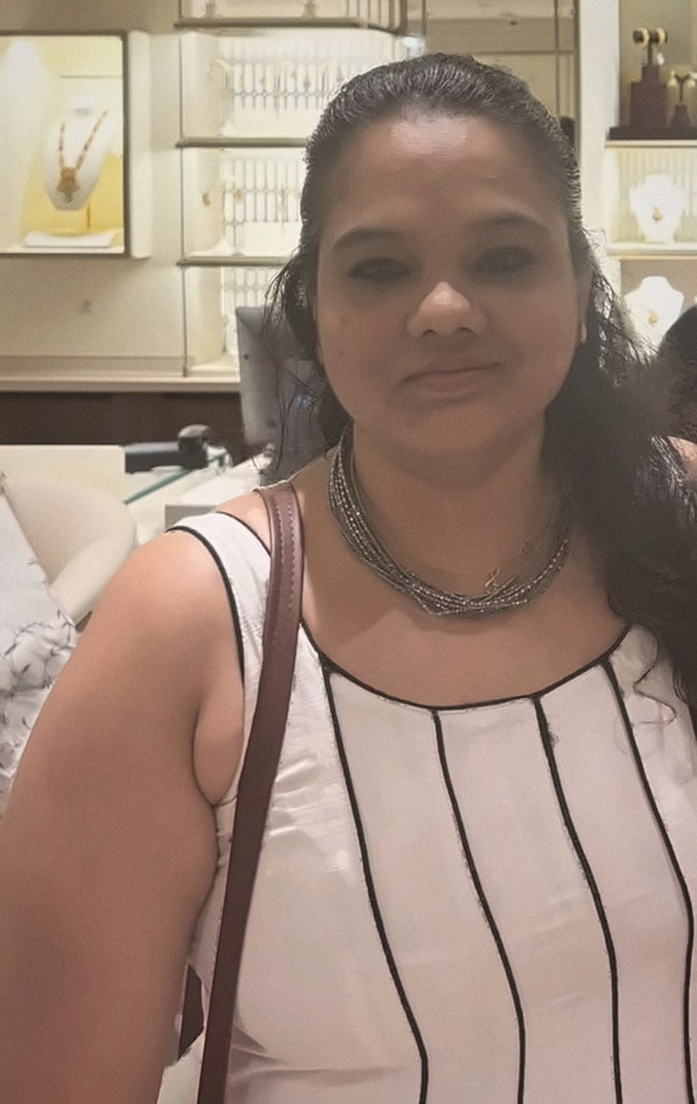 Diviya S Chachra in a white dress with black piping